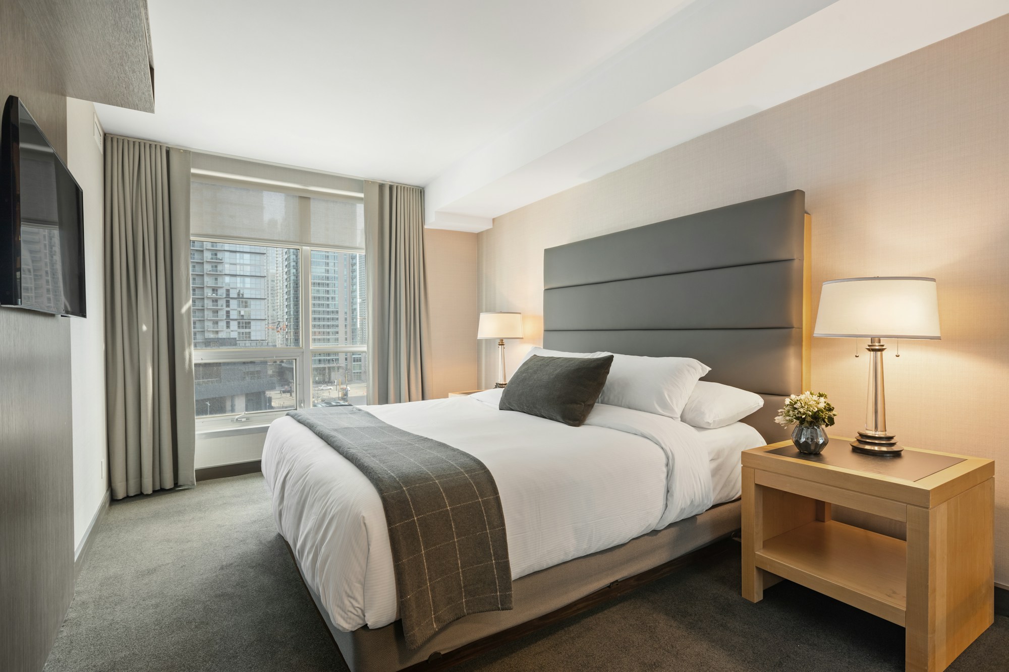 Luxury white bedsheet on a neatly made bed in a modern bedroom